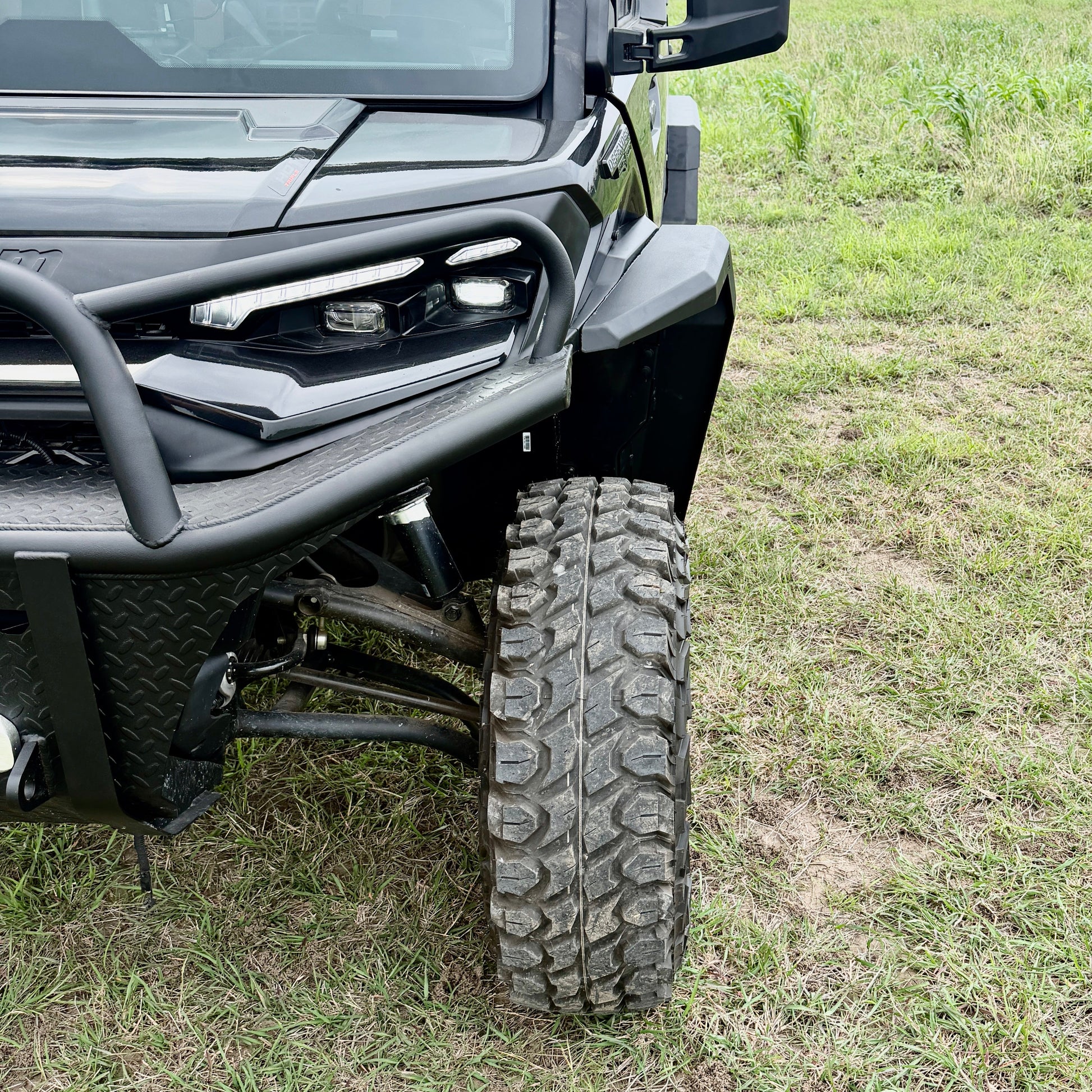 Bolt-on aluminum fender flares engineered for the Can-Am Defender HD11 UTV with oversized tire clearance.