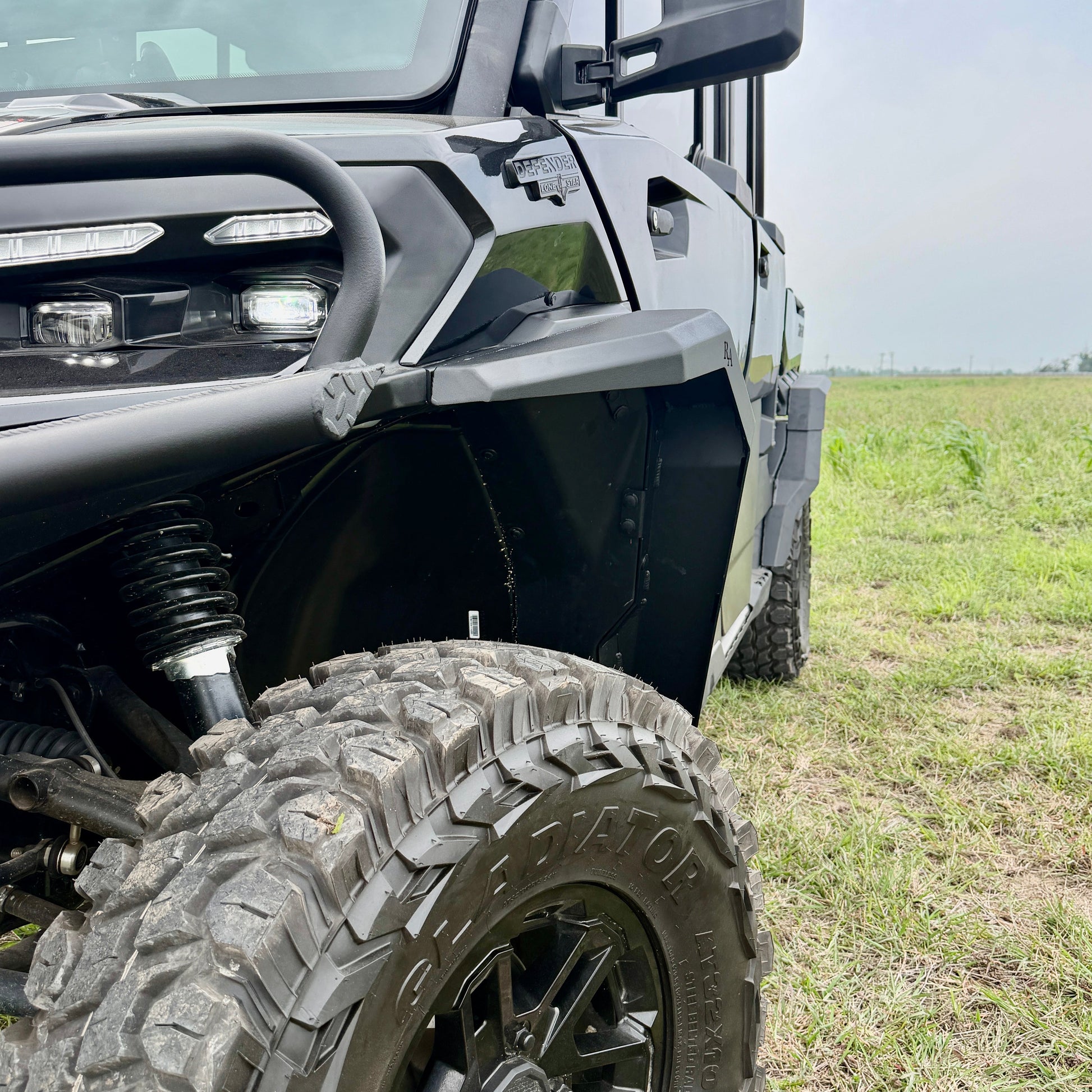 Can-Am Defender HD11 aluminum fender flares installed on a UTV for added mud and debris protection.
