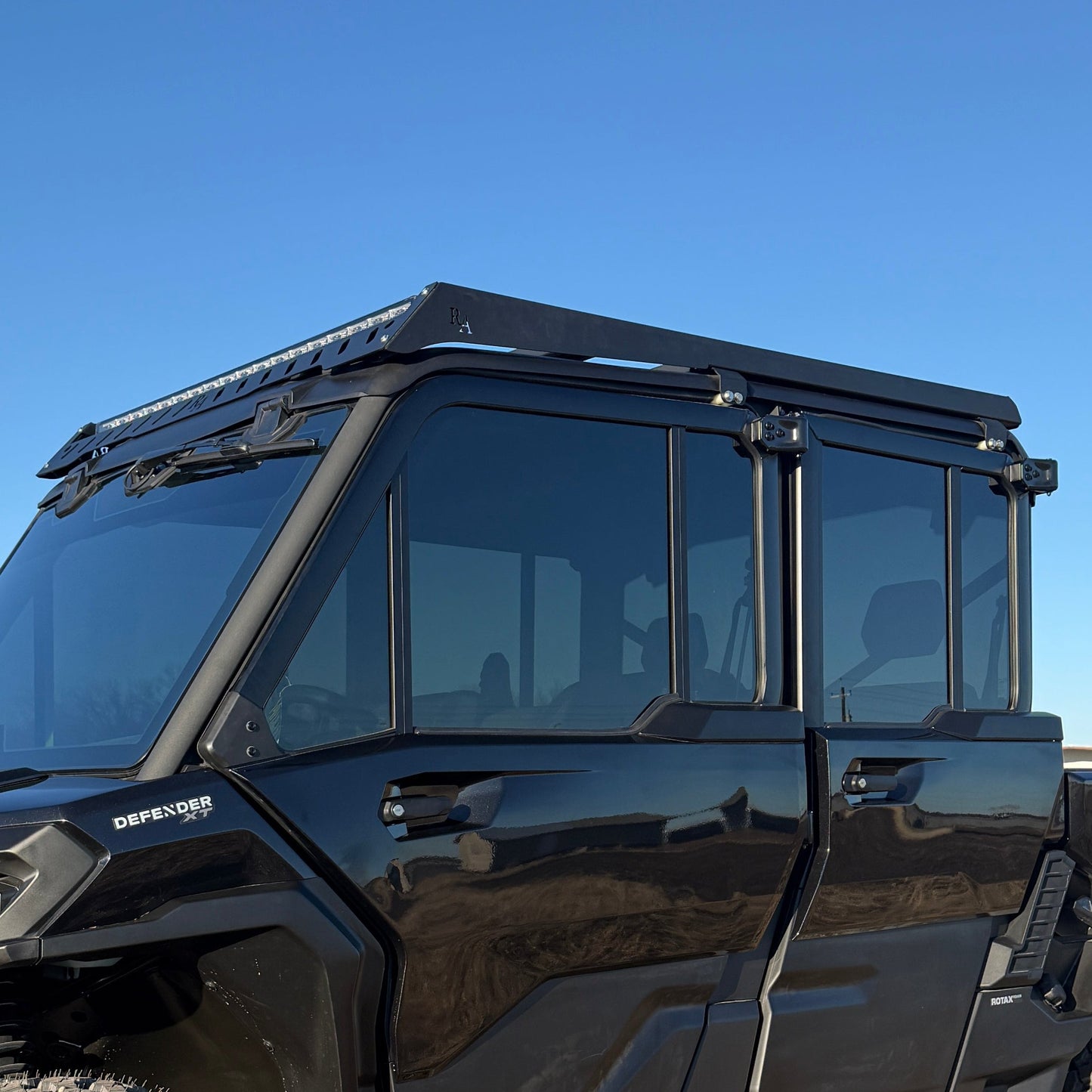 Can-Am Defender UTV roof rack with integrated light mounting tabs by Ranch Armor