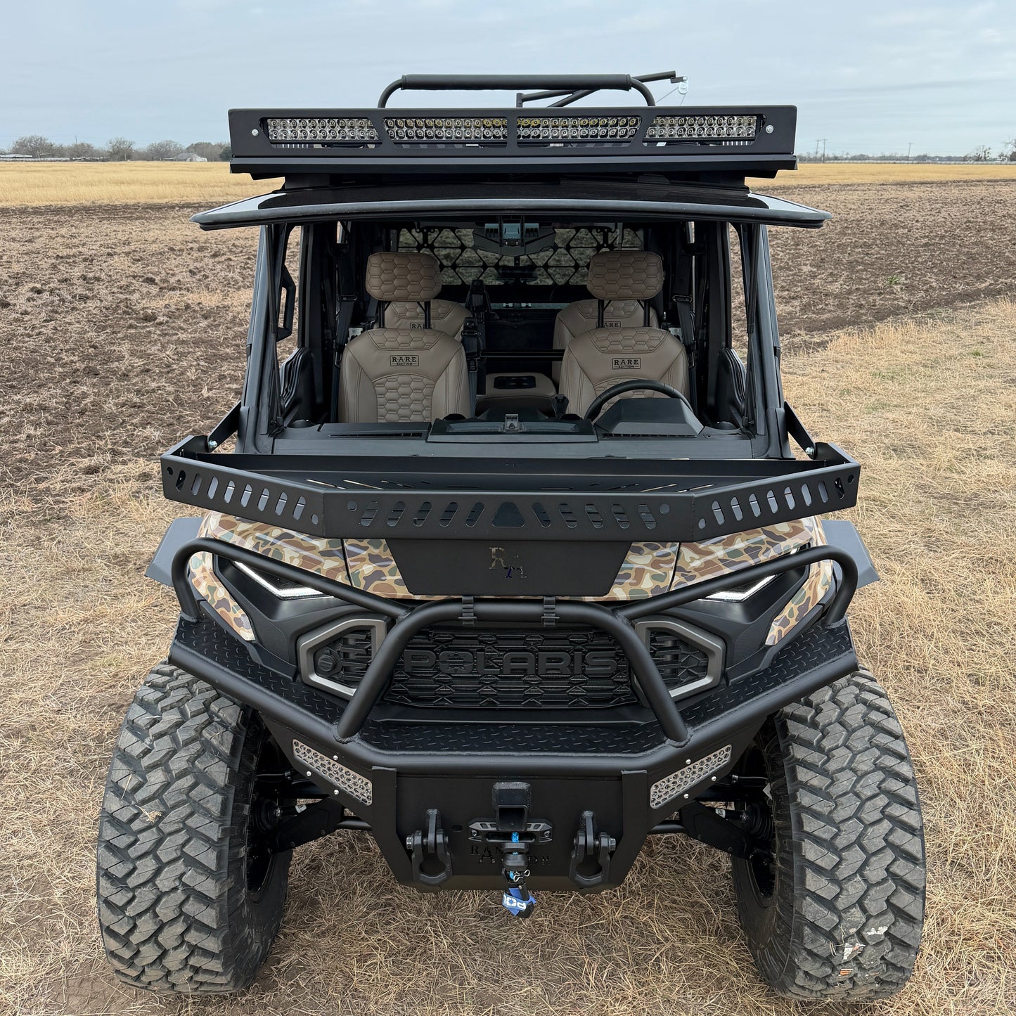 Custom Polaris Ranger 1500 Project Kudu build combining utility flatbed, camo wrap, and premium interior