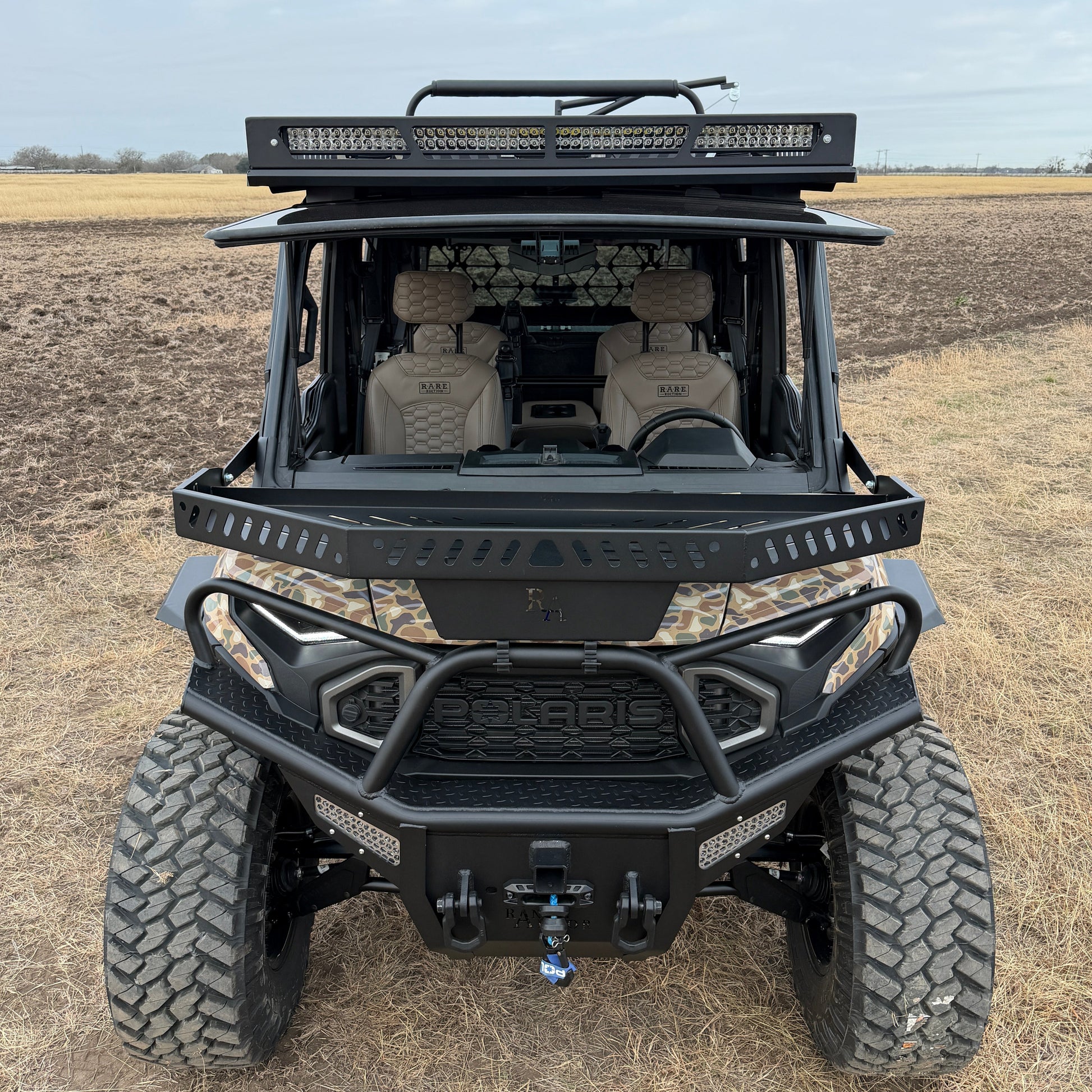Custom Polaris Ranger 1500 Project Kudu build combining utility flatbed, camo wrap, and premium interior