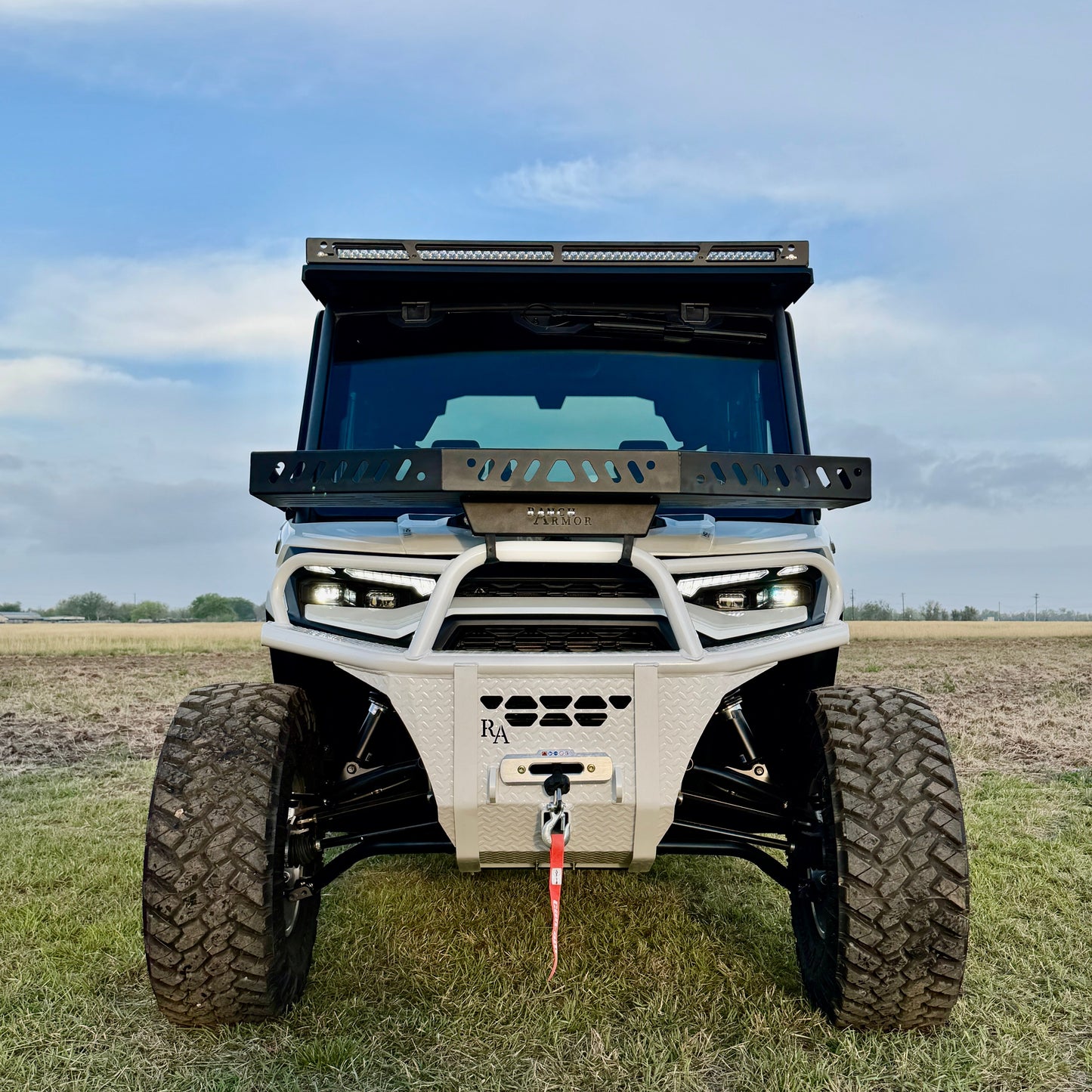Front view of Can-Am Defender HD11 with hybrid white front bumper installed
