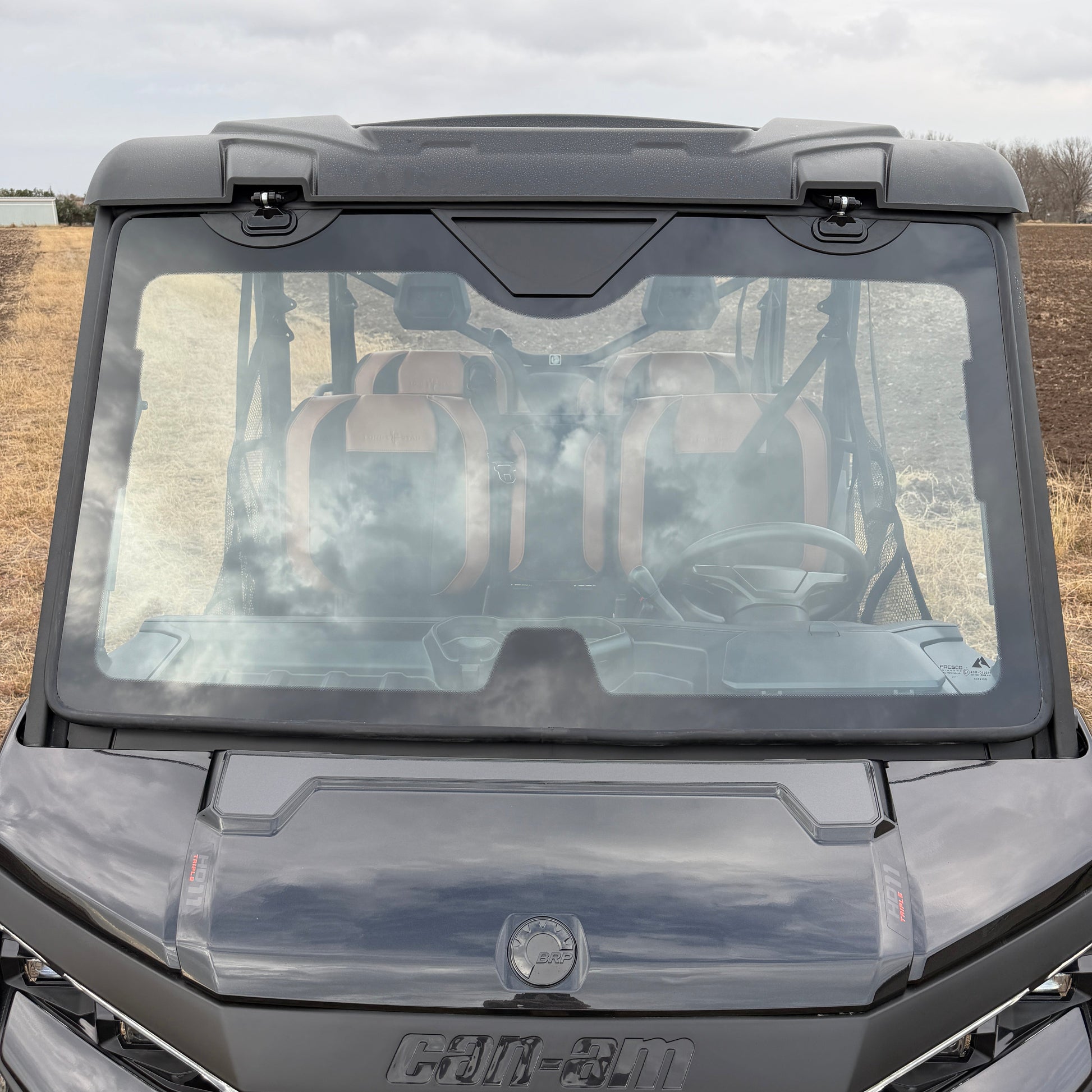 OEM-fit Can-Am glass tip-out windshield opening fully or in vent mode with improved seal compared to stock windshield.