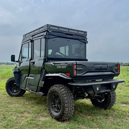 Off-road Can-Am Defender HD11 equipped with aftermarket aluminum fender flares for enhanced protection.