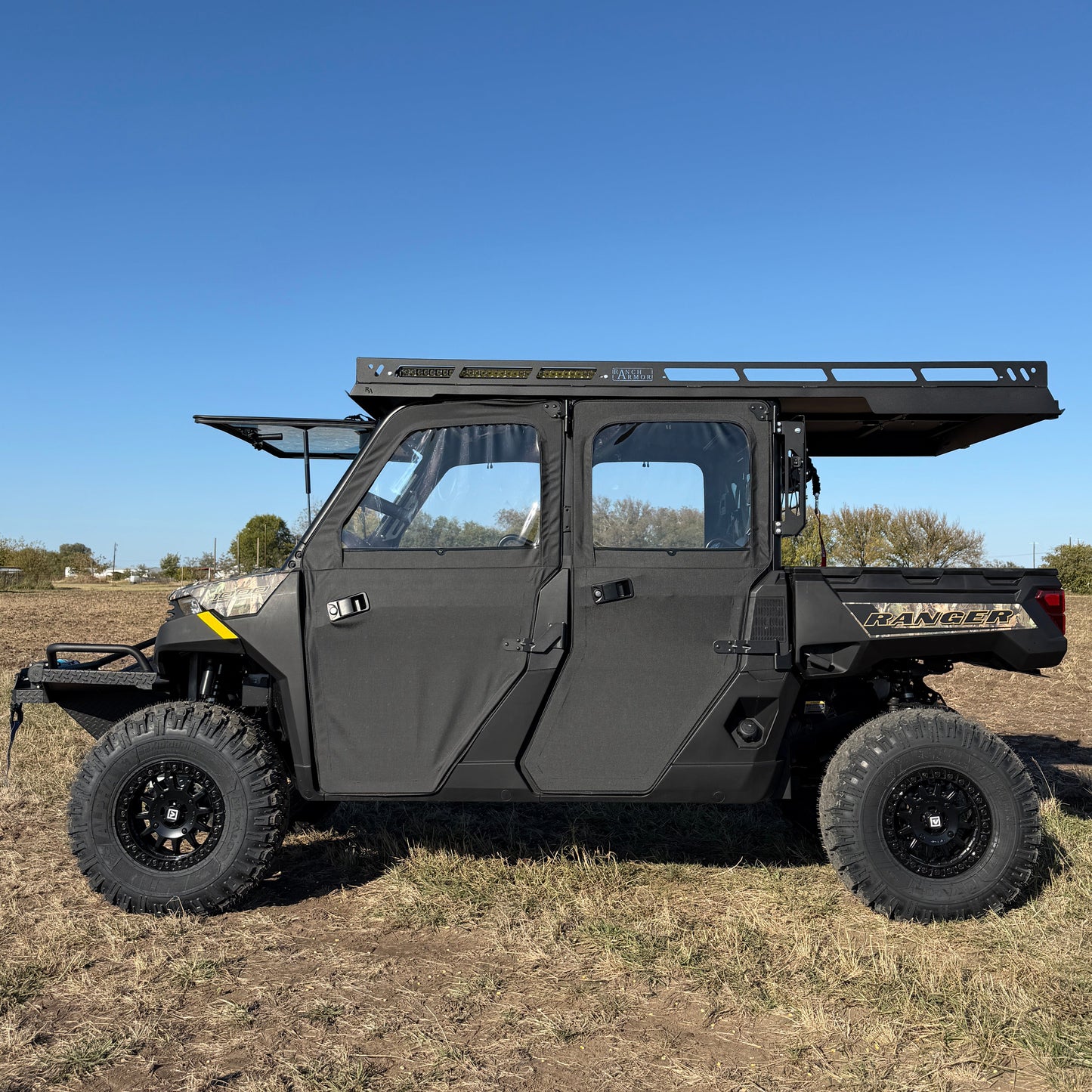 Polaris Ranger 1000 with extended aluminum roof covering cab and bed for added protection
