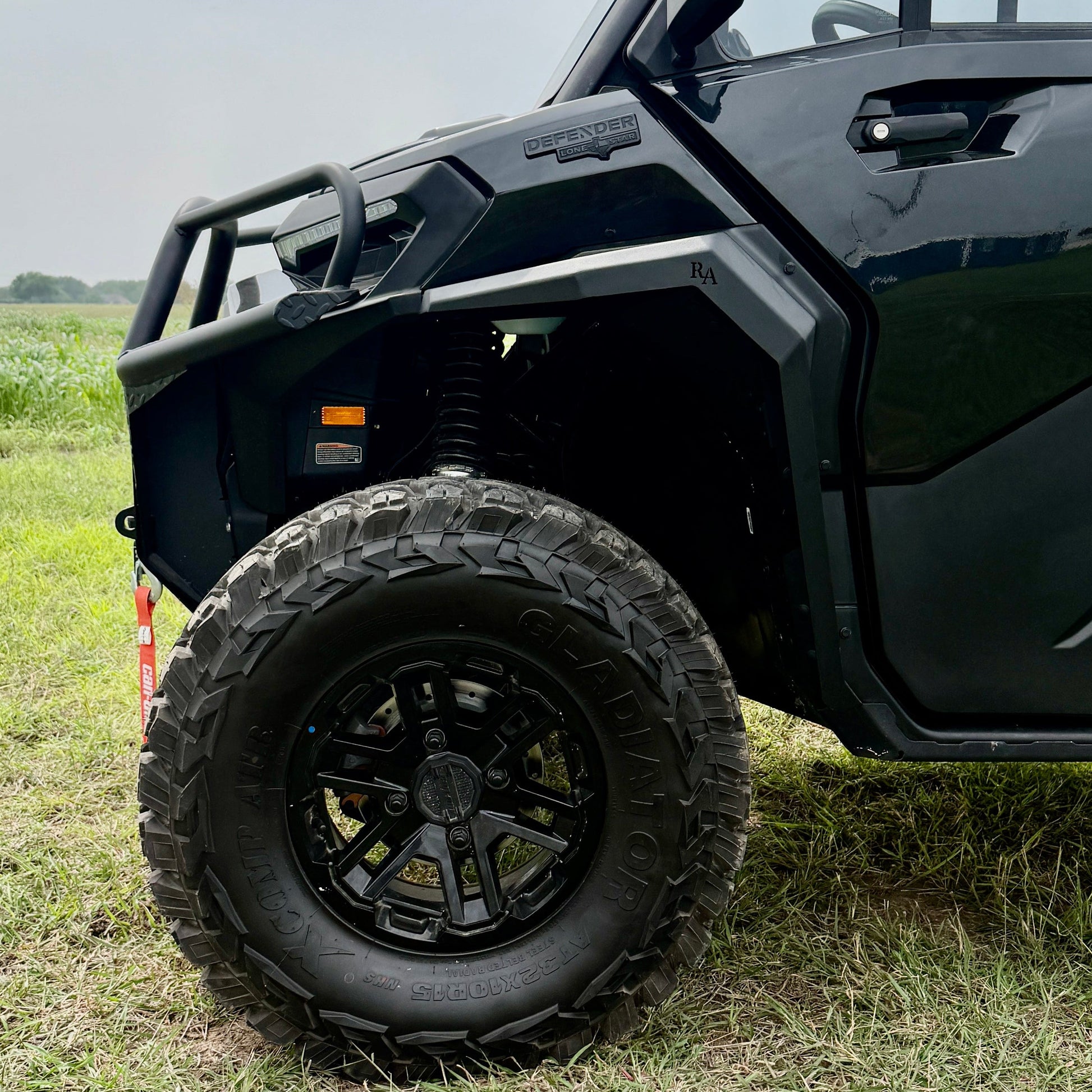 Rugged black aluminum fender flares mounted on a Can-Am Defender HD11 utility terrain vehicle.