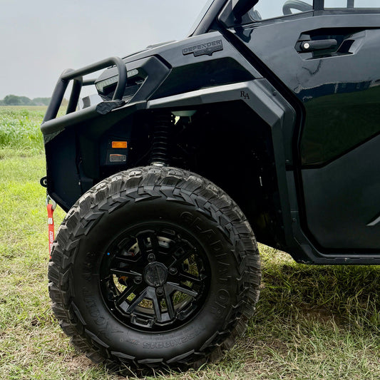 Rugged black aluminum fender flares mounted on a Can-Am Defender HD11 utility terrain vehicle.