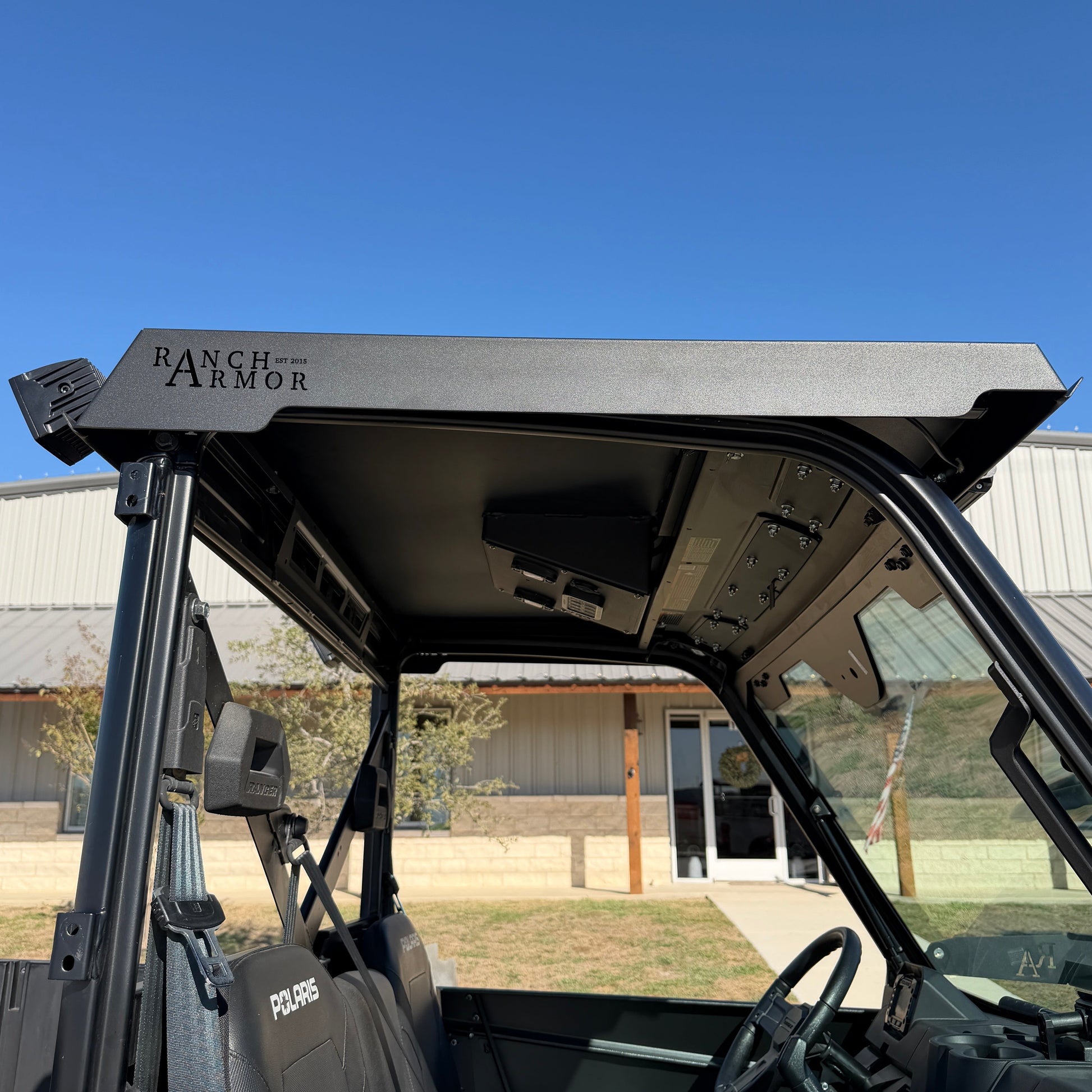 Single cab Polaris Ranger 1000 featuring durable steel metal top for all-weather protection